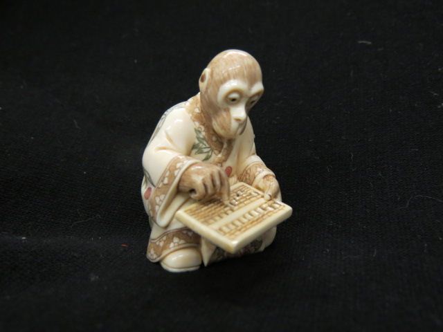 Appraisal: Carved Ivory Netsuke of Monkeywith an abacus tall signed excellent