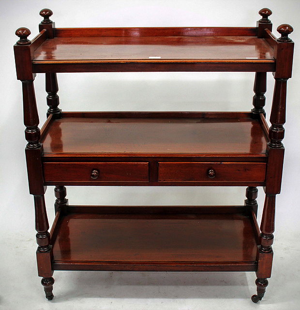 Appraisal: A VICTORIAN MAHOGANY THREE TIER BUFFET with turned supports and