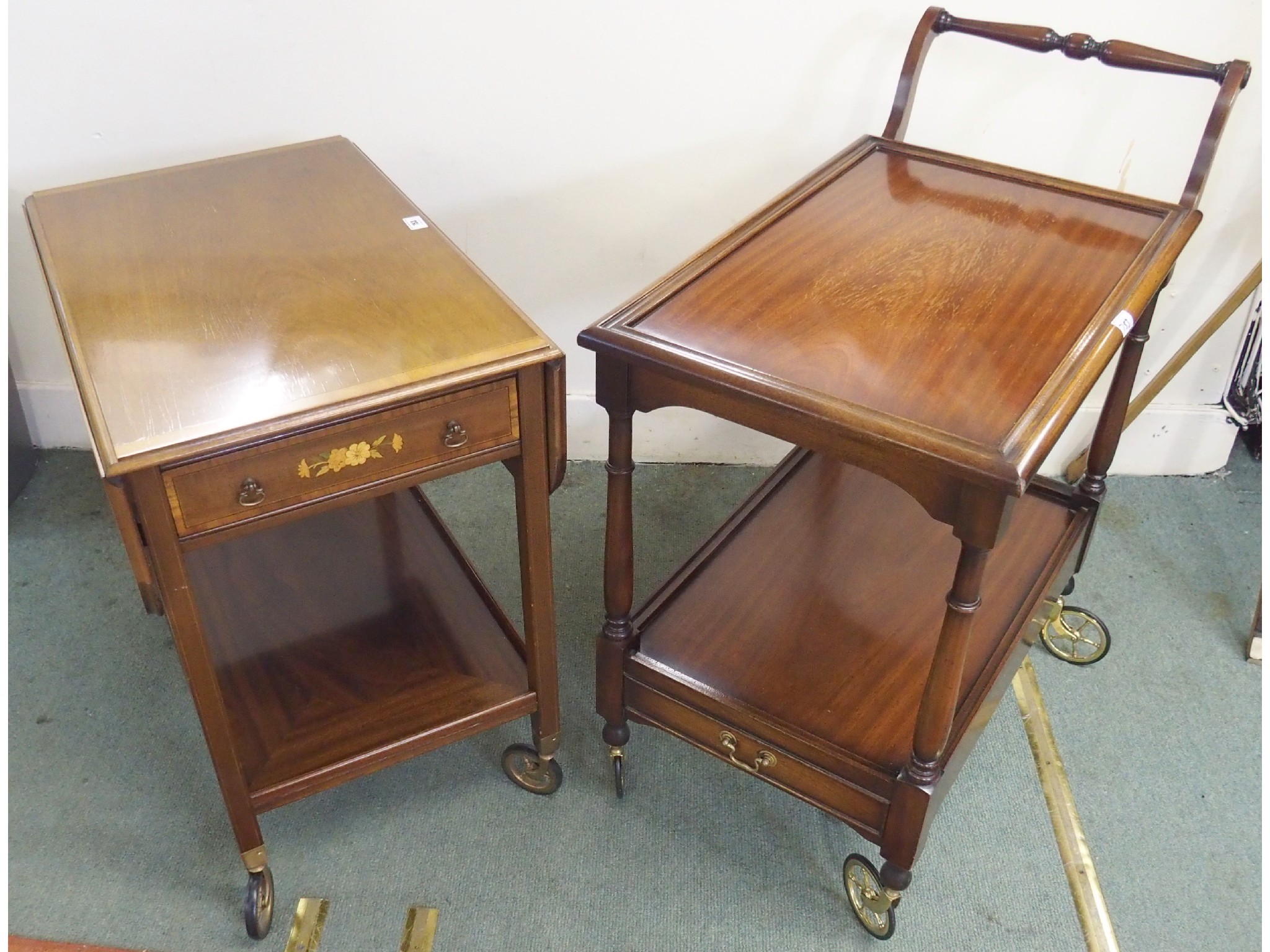 Appraisal: A mahogany tea trolley with tray and an inlaid tea