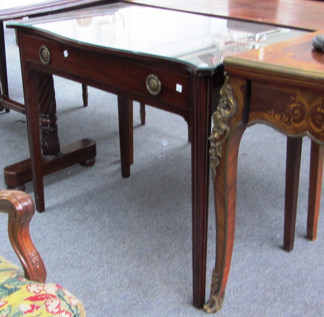 Appraisal: A George III mahogany writing table the serpentine top over