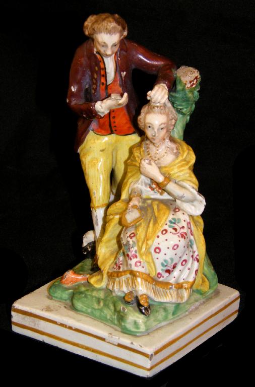 Appraisal: Early Staffordshire Prattware type group modelled as a gentleman hairdresser