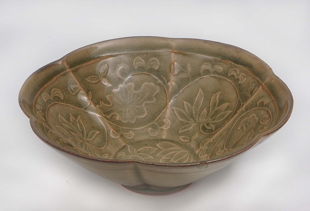 Appraisal: A Chinese celadon lobed bowl th th Centurywith delicate raised