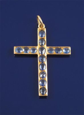 Appraisal: A gold cruciform pendant mounted with sapphires cm high