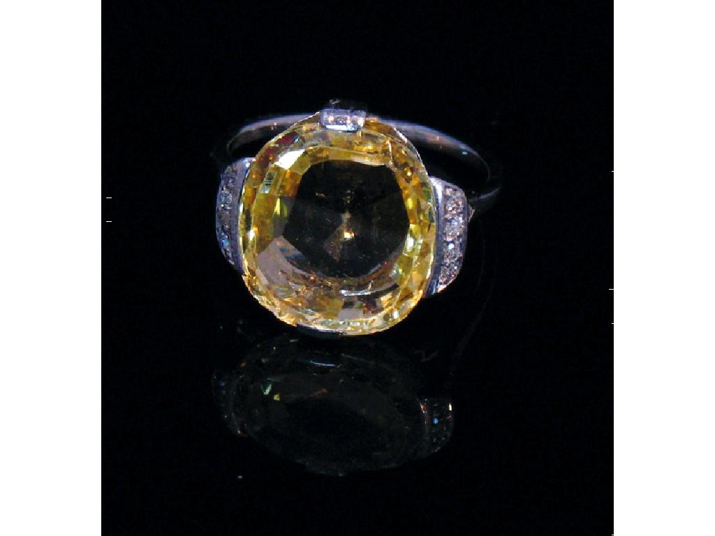 Appraisal: A YELLOW SAPPHIRE DRESS RING the large cushion-cut yellow sapphire