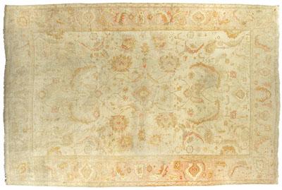 Appraisal: Oushak carpet repeating floral and leaf designs flanking small central