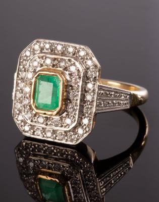 Appraisal: An emerald and diamond cluster ring the emerald cut central