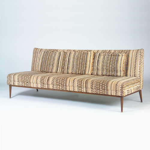 Appraisal: PAUL McCOBB Three-seat armless sofa with woven fabric upholstery in