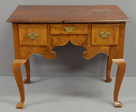 Appraisal: Georgian walnut lowboy with a molded top and cabriole legs