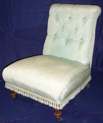 Appraisal: A Victorian upholstered nursing chair with button back on turned