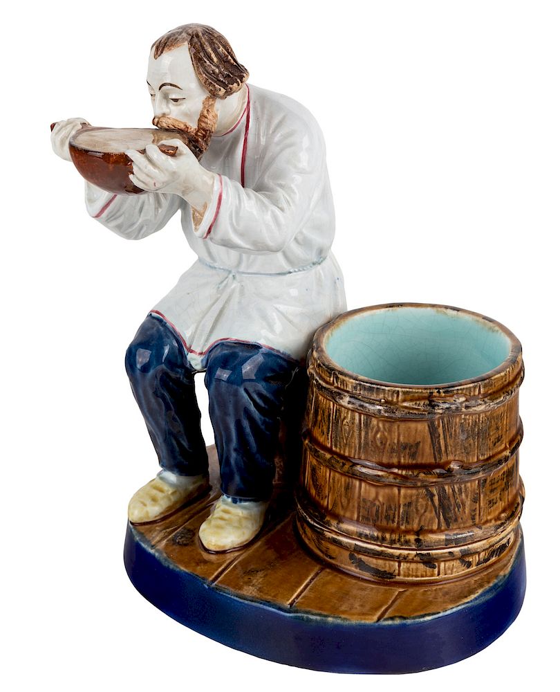 Appraisal: A RUSSIAN PORCELAIN FIGURE OF A PEASANT DRINKING FROM A