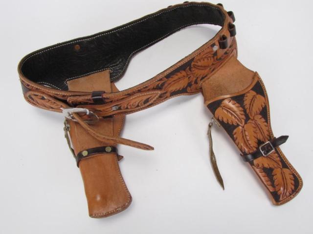 Appraisal: Tooled leather cowboy-style double holster gun belt leaf design