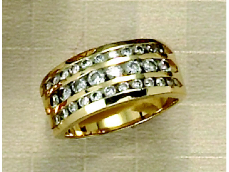 Appraisal: DIAMOND WEDDING RING Yellow gold lady's ring with triple row