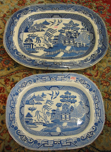 Appraisal: TWO CHINESE BLUE WILLOW PORCELAIN PLATTERS complete with wall hangers