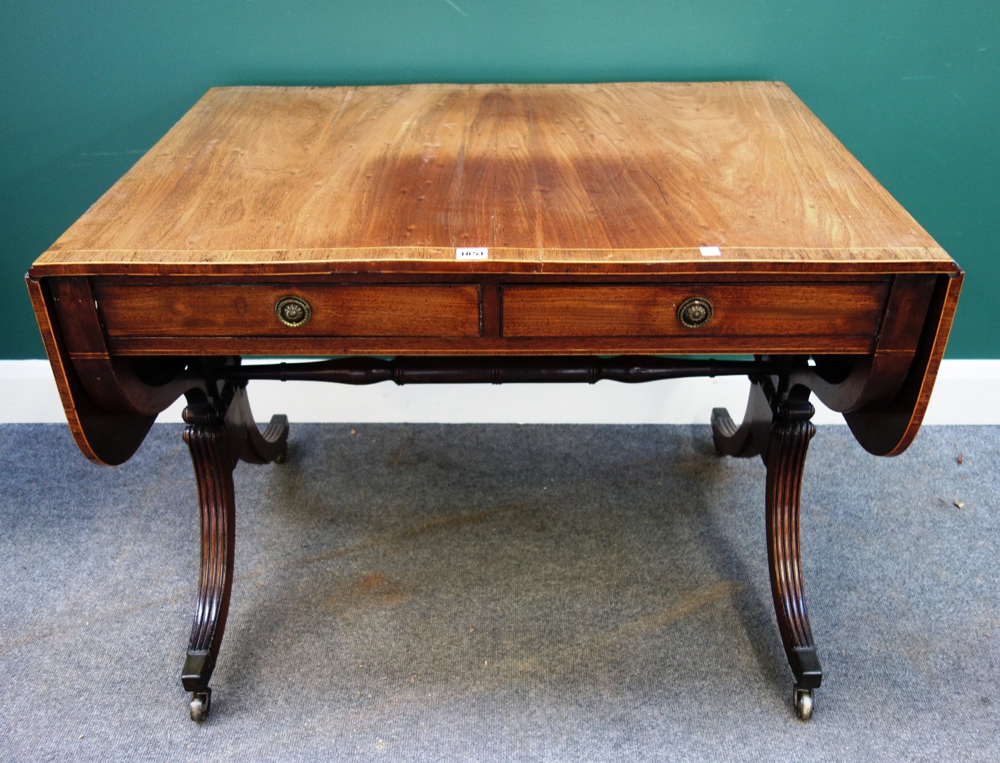 Appraisal: A Regency rosewood banded mahogany sofa table on four downswept