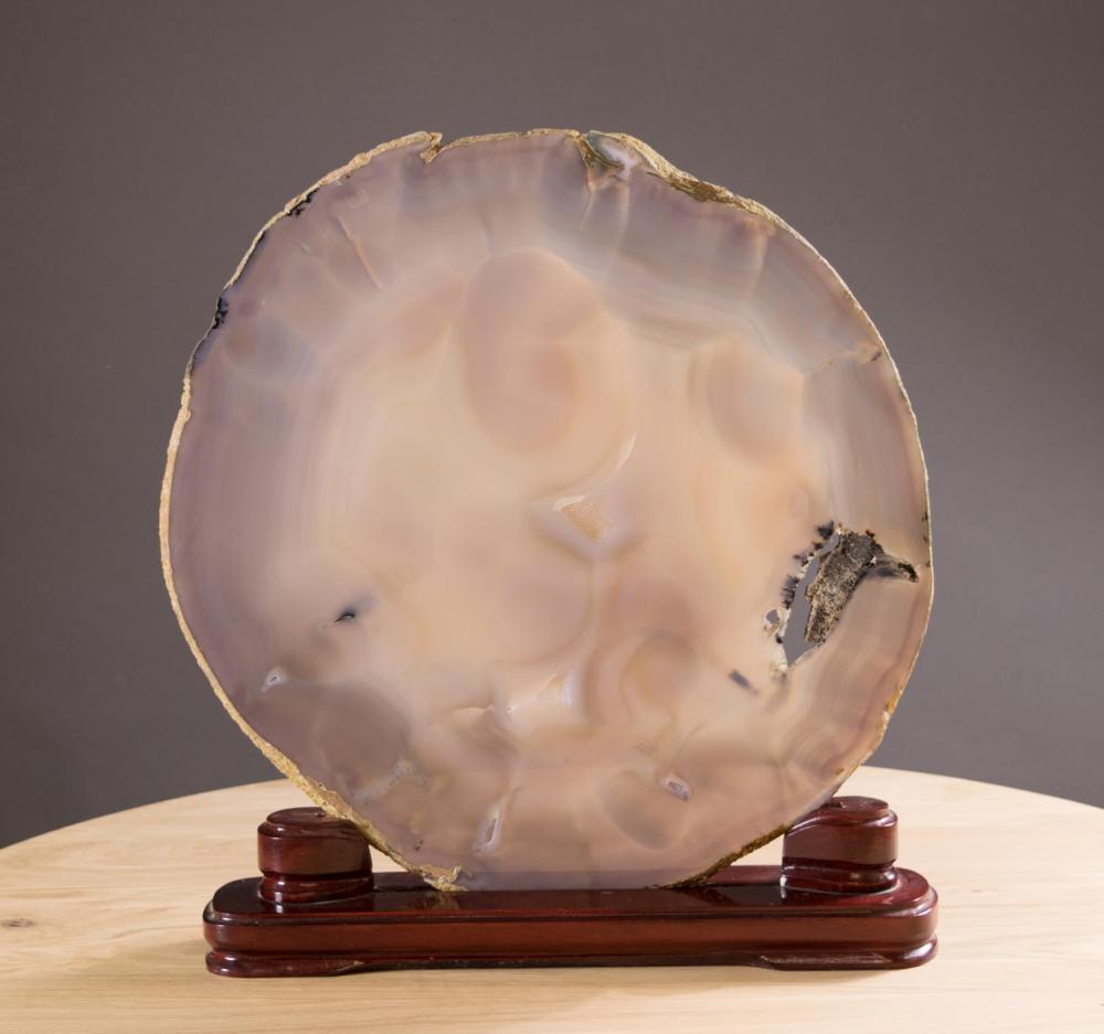 Appraisal: BRAZILIAN AGATE CROSS SECTION SLICE raised on wooden display plinth