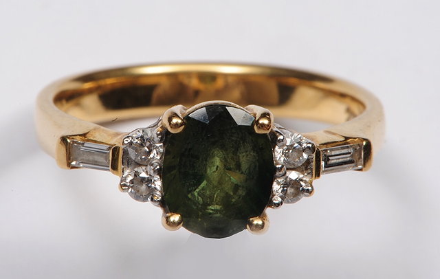 Appraisal: A CT GOLD RING set with central emerald with diamonds