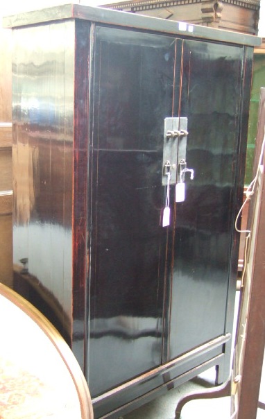 Appraisal: A late th century Chinese black lacquer two door wardrobe