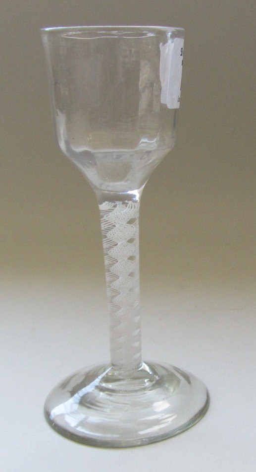 Appraisal: An opaque twist wine glass circa the moulded ogee bowl