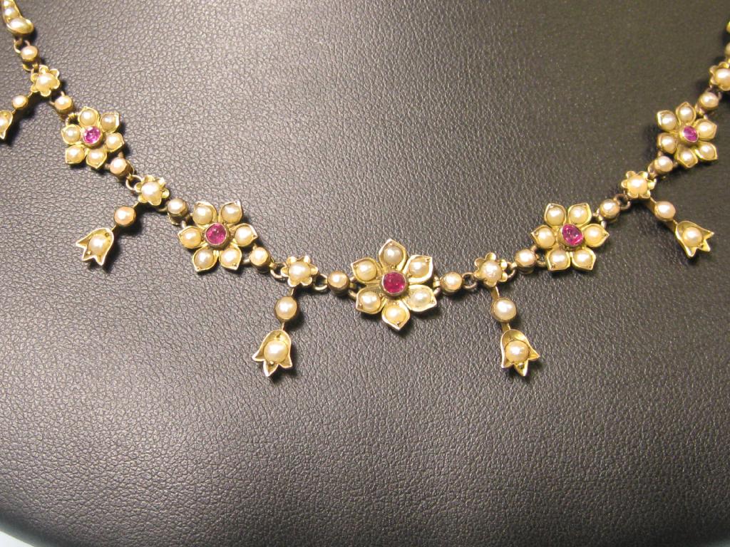 Appraisal: A seed Pearl and Ruby Necklace the front having five