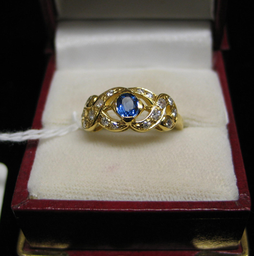 Appraisal: SAPPHIRE DIAMOND AND FOURTEEN KARAT GOLD RING centering a round