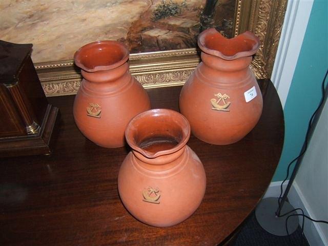 Appraisal: A graduated set of three Wedgwood terracotta jugs of baluster