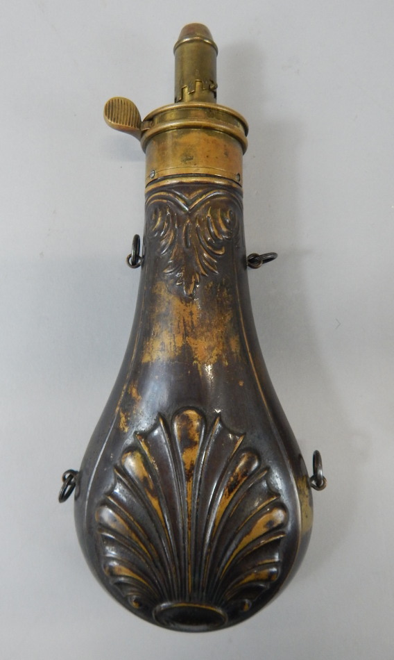 Appraisal: A brass powder flask embossed with a leaves and shells