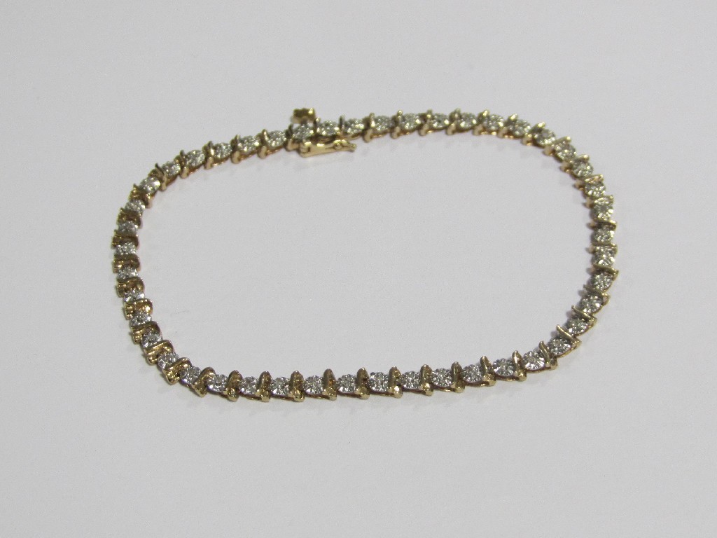 Appraisal: Nine carat bi colour gold diamond line bracelet