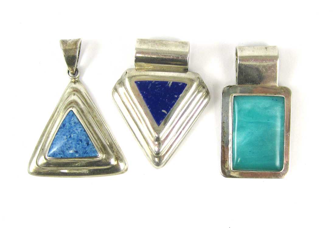 Appraisal: THREE STERLING SILVER PENDANTS including a sterling pendant set with