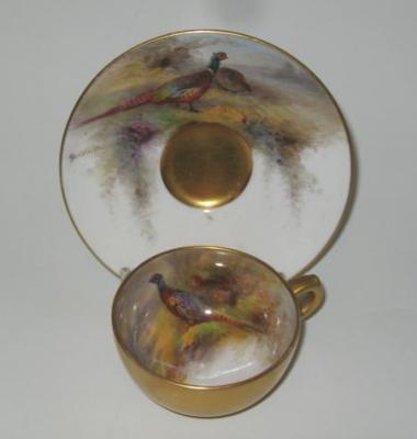 Appraisal: A ROYAL WORCESTER PORCELAIN MINIATURE CUP AND SAUCER painted with