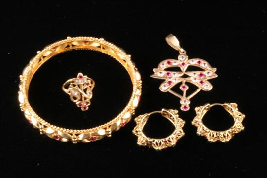 Appraisal: FOUR GEMSET ITEMS OF K YELLOW GOLD One ruby bangle