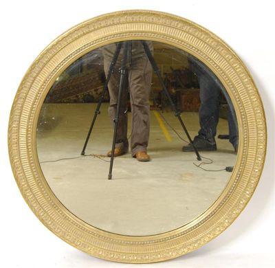 Appraisal: A giltwood and gesso circular wall mirror with a bead