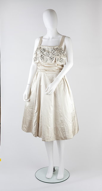 Appraisal: A cream silk full skirted dress circa with beadwork to