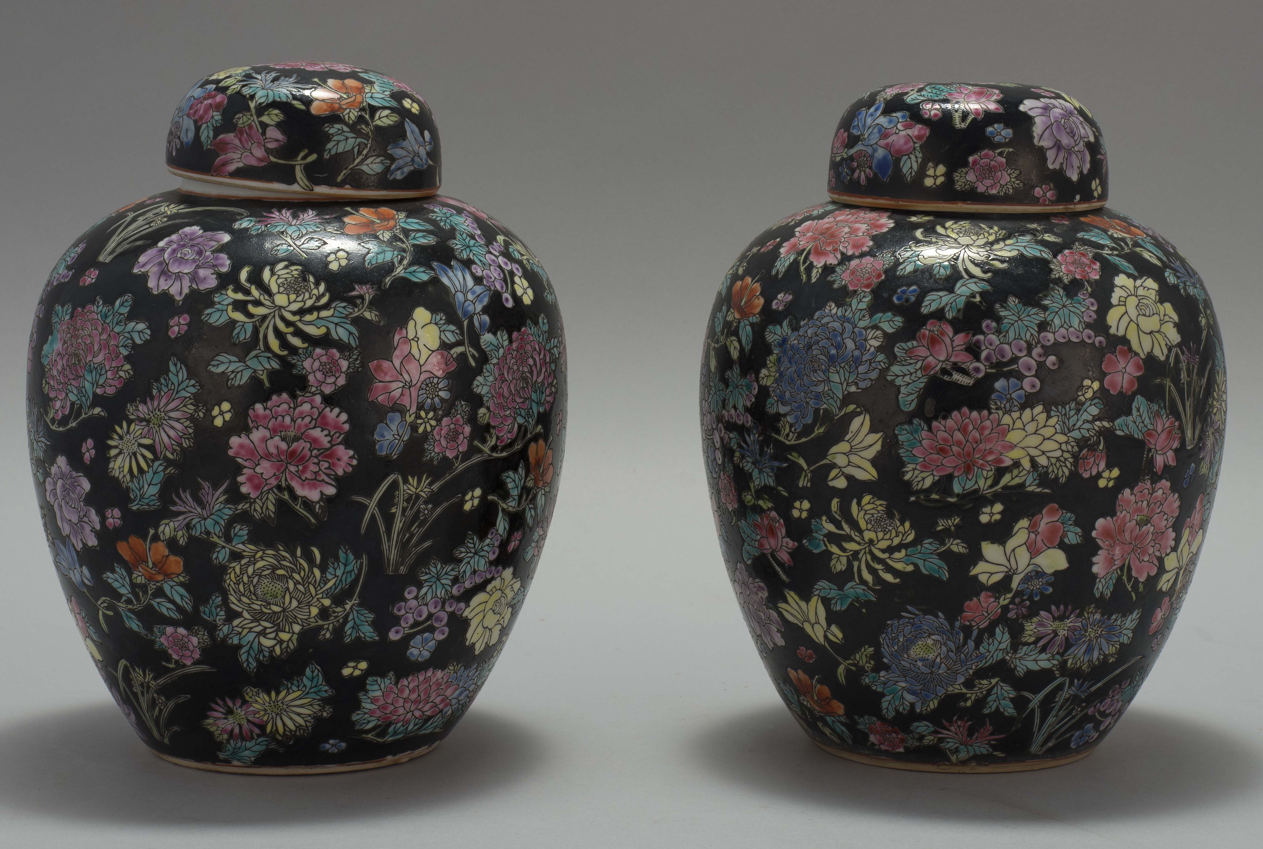 Appraisal: PAIR OF FAMILLE NOIRE PORCELAIN COVERED JARS Chinese th CenturyIn