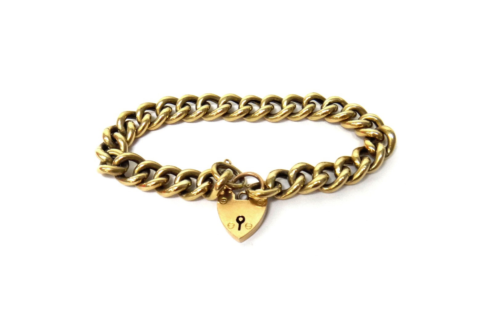 Appraisal: A gold curb link bracelet on a gold heart shaped