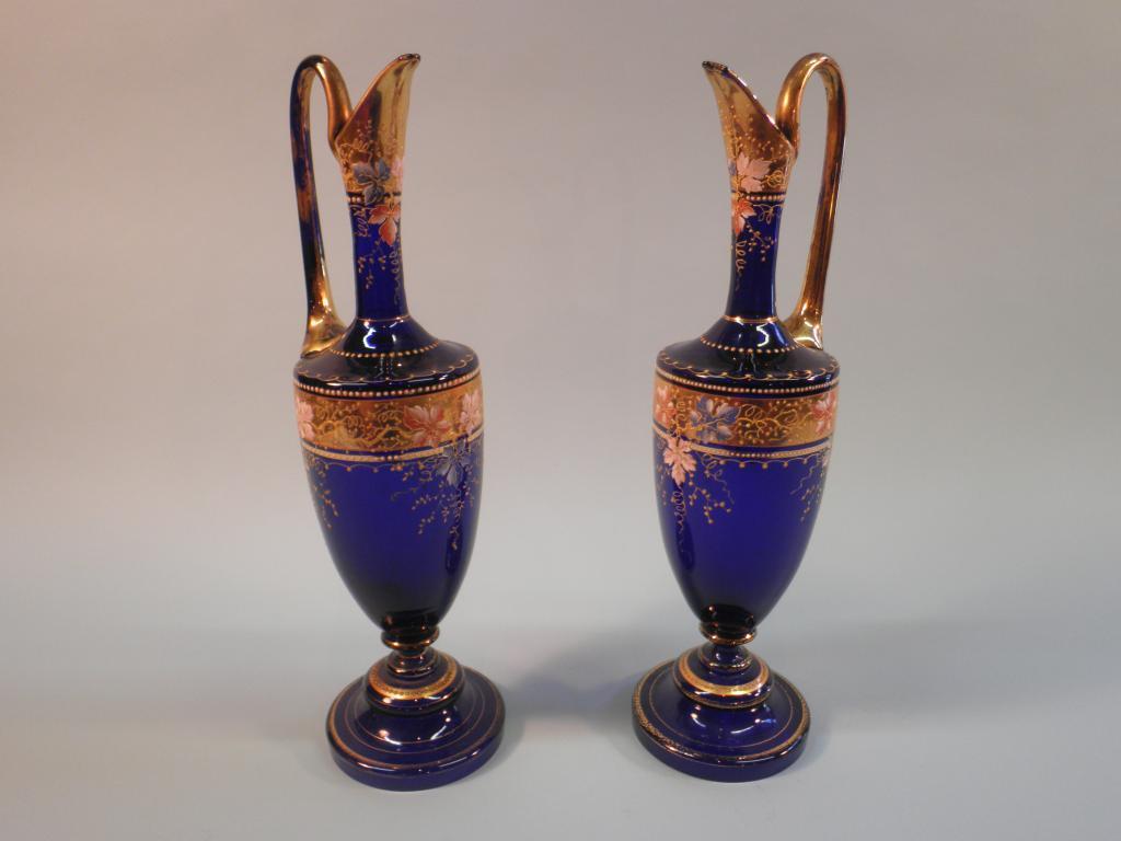 Appraisal: A pair of Venetian blue glass ewers each decorated in