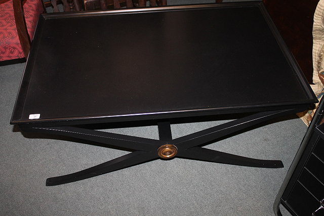 Appraisal: A CONTEMPORARY BLACK COFFEE TABLE with 'X' shaped supports cm