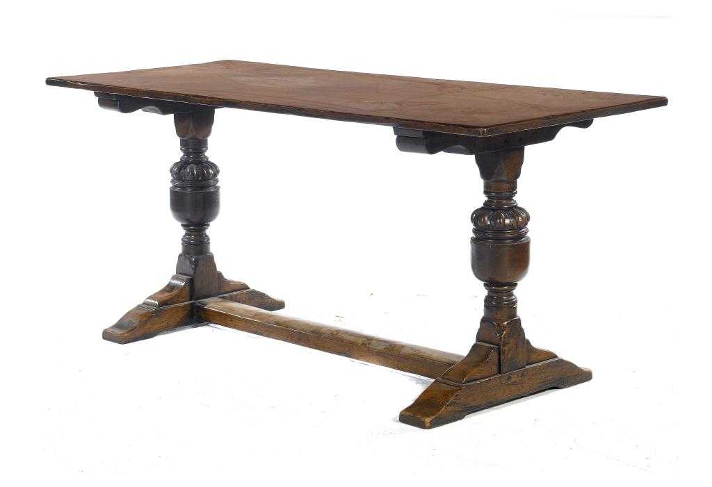 Appraisal: AN OAK TABLE the boarded rectangular top on substantial bearers