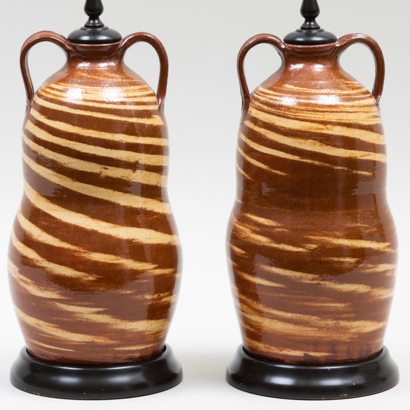 Appraisal: PAIR OF GLAZED EARTHENWARE SLIP DECORATED JARS MOUNTED AS LAMPS