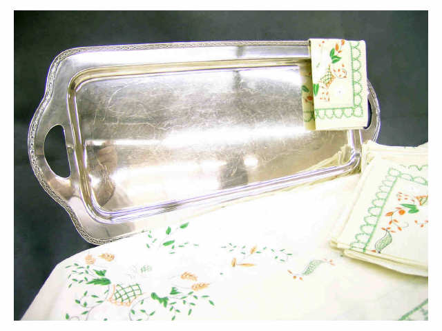 Appraisal: Silverplated handled serving platter x and floral pattern table linens