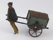 Appraisal: A vintage inertia drive tinplate man pulling a handcart action