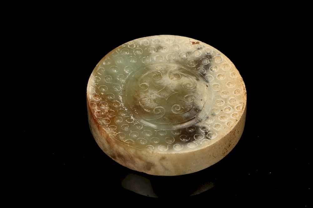 Appraisal: EARLY CHINESE JADE SWORD POMMEL Of a circle sectioned decorated