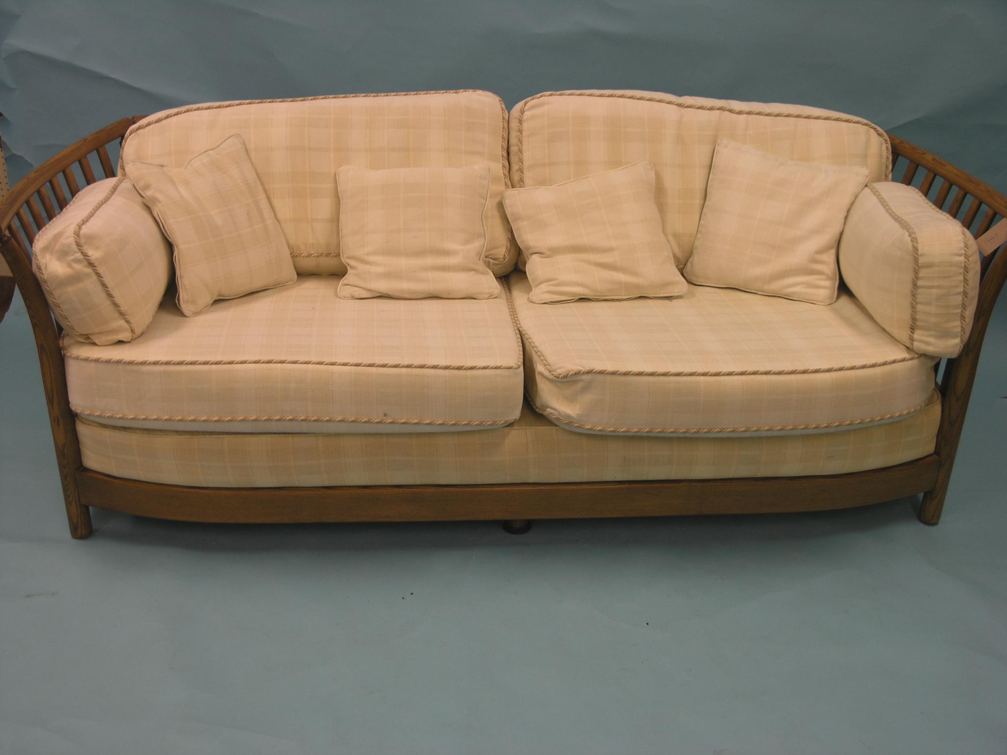 Appraisal: An Ercol medium elm two-seater settee stick-back frame with cream