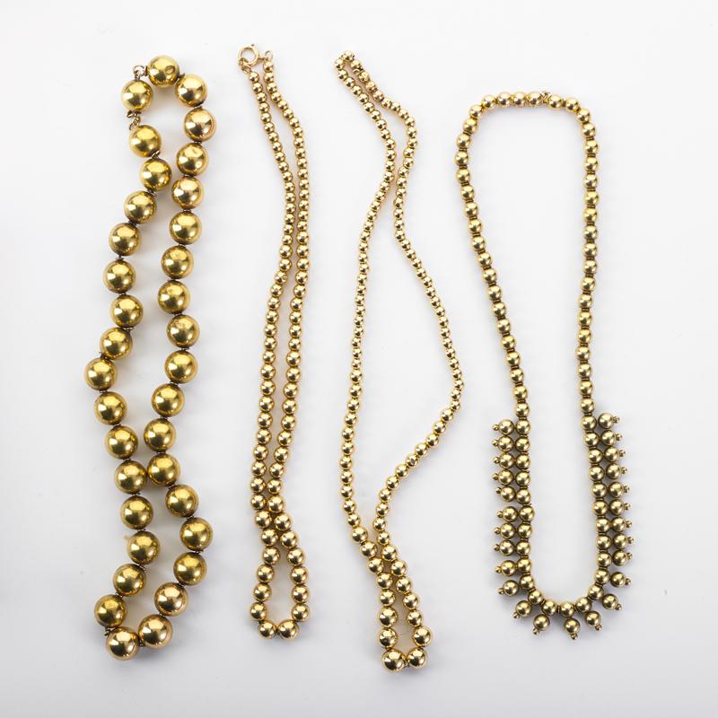 Appraisal: FOUR YELLOW GOLD BEAD NECKLACES Condition Report Some beads dented