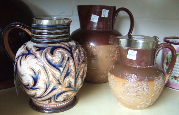 Appraisal: A Doulton Lambeth saltglaze stoneware jug with incised leaf decoration