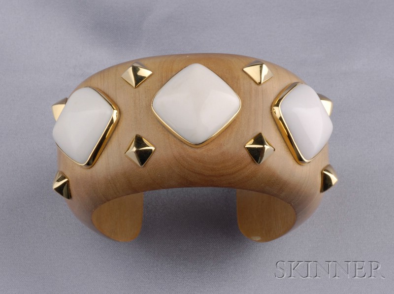 Appraisal: Sandalwood and Kocholong Stone Cuff Trianon set with pyramidal cabochons