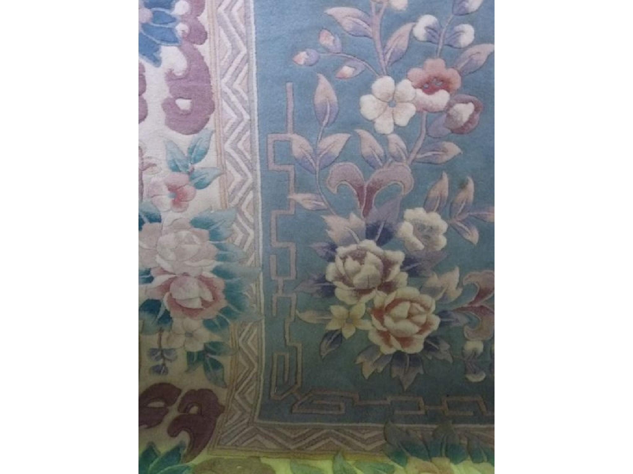 Appraisal: A Chinese blue ground washed wool carpet with pastel shade