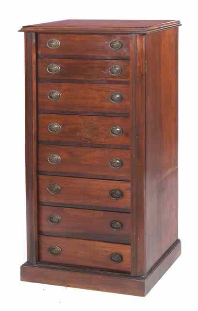 Appraisal: A MAHOGANY WELLINGTON CHEST with eight graduated drawers and on