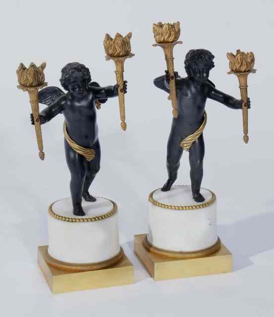 Appraisal: A PAIR OF REGENCY STYLE BRASS FIGURES of winged cherubs