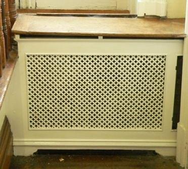 Appraisal: A pierced cast radiator panel with wooden top on bracket