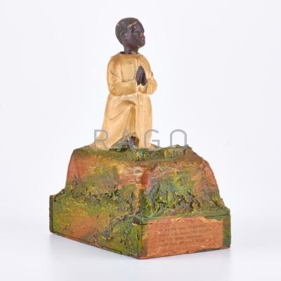 Appraisal: GERMAN Wooden alms box with bobblehead African boy kneeling in